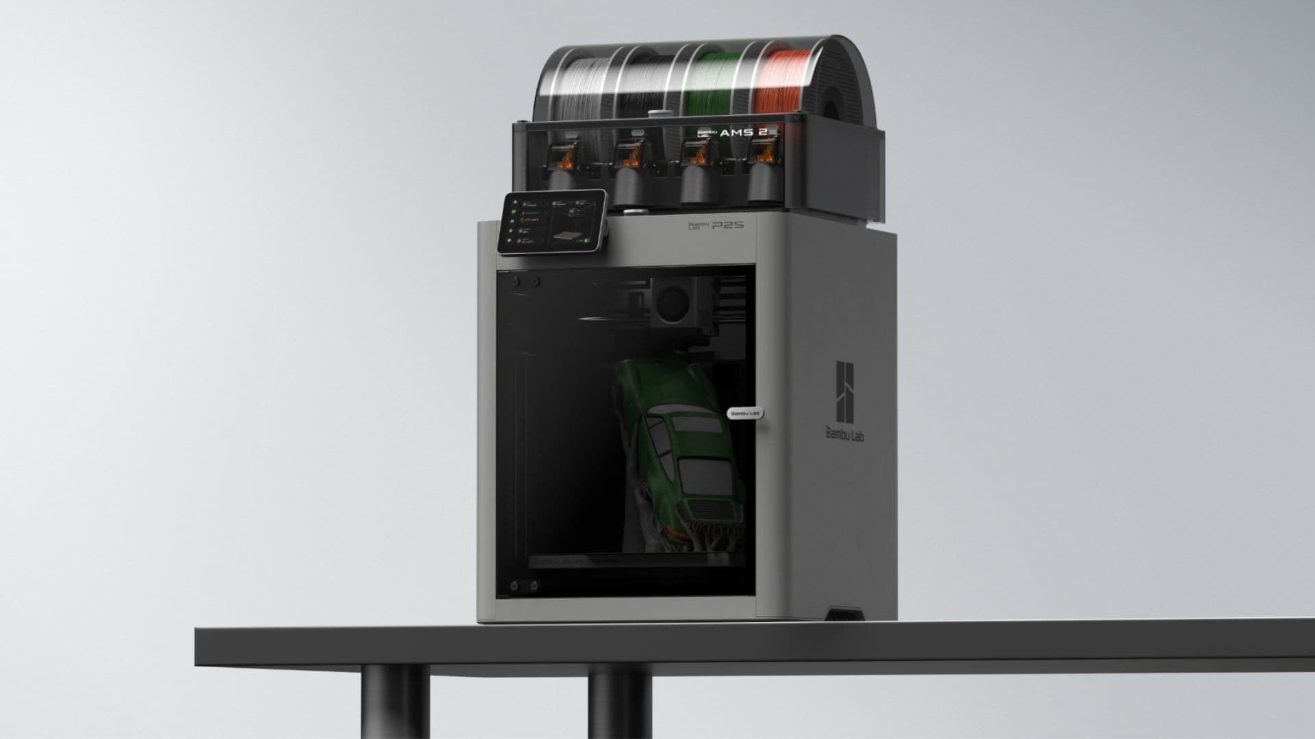 Official Bambu Lab P2S Combo with AMS 2 Pro, colored filament spools, and a green printed car inside the enclosure