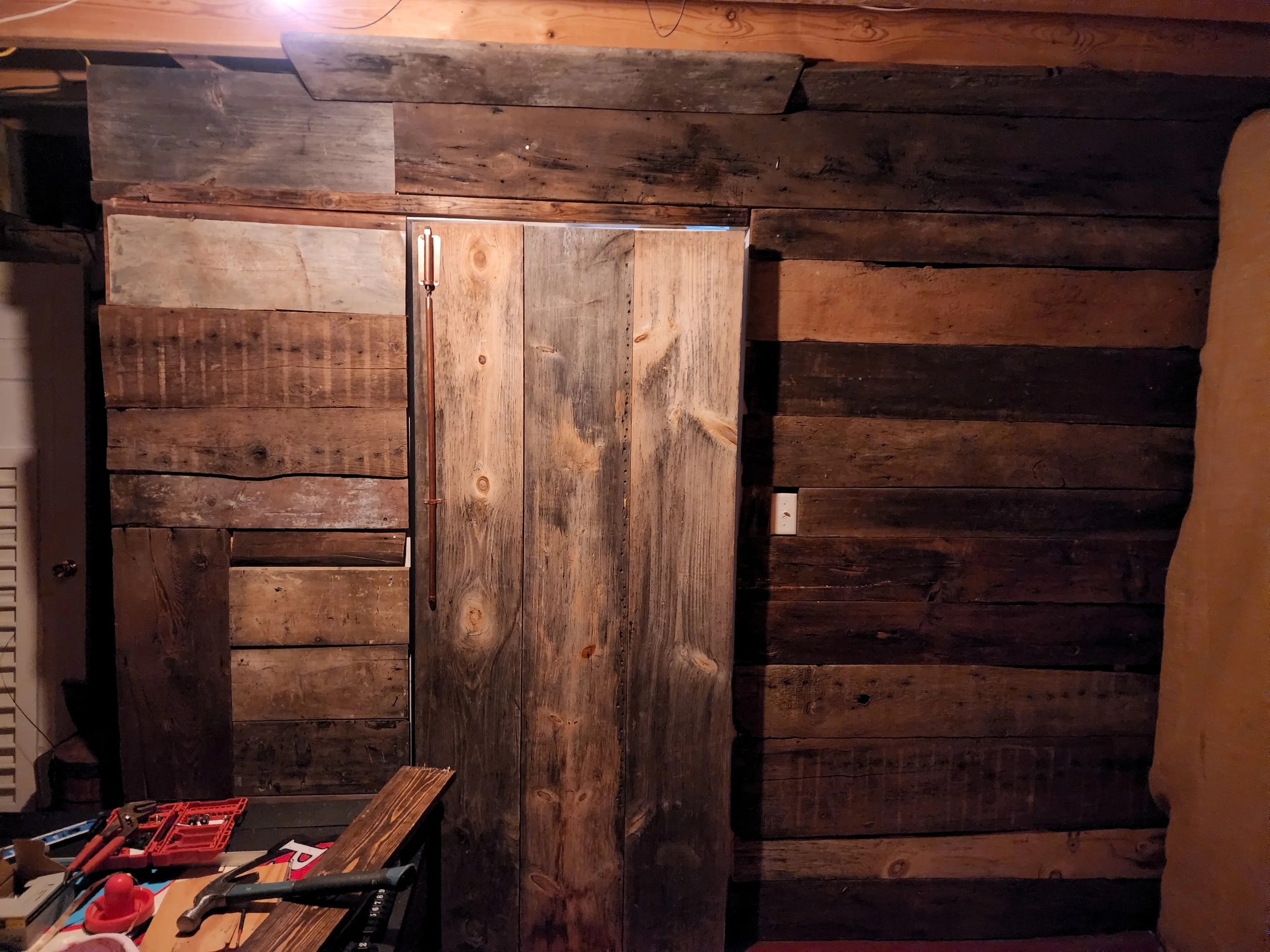 secret room ideas, rustic wall, secret door, swinging bookcase with rustic wood back.