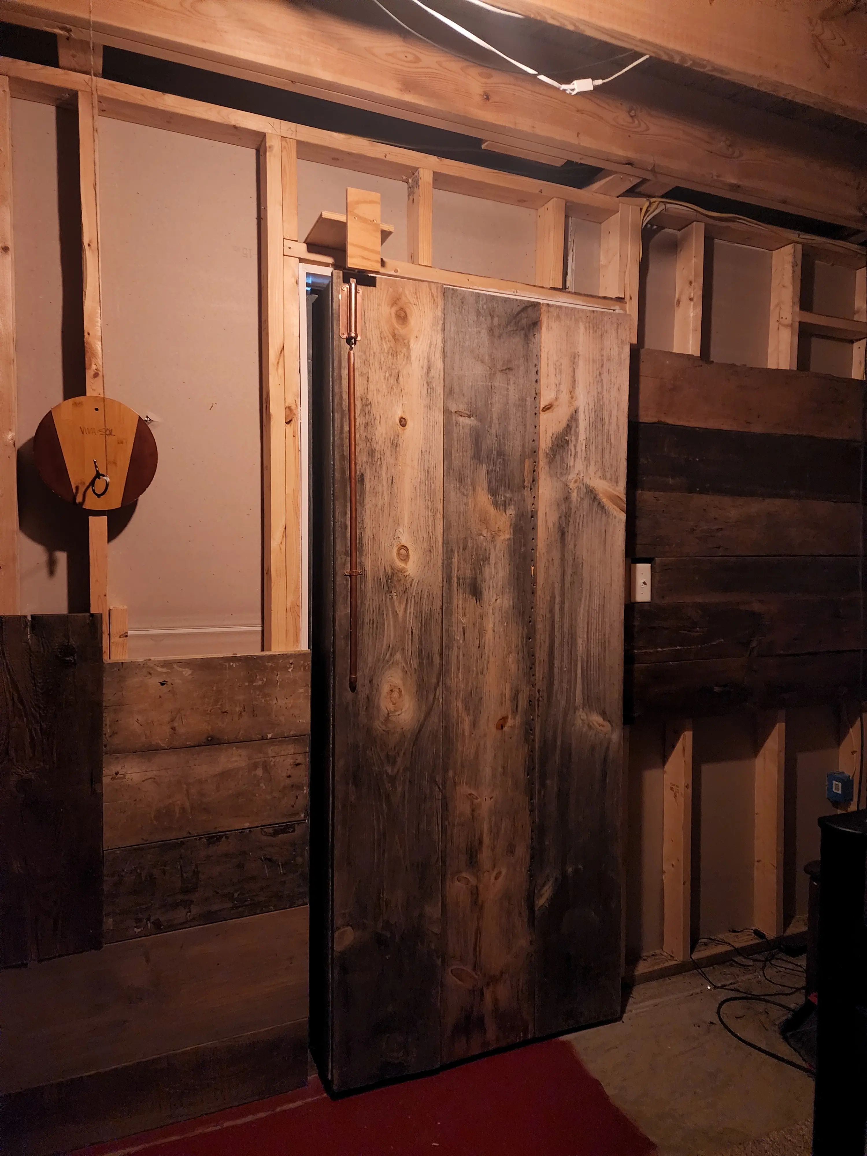 rustic wall wood secret room bookcase door, hand hewn beams