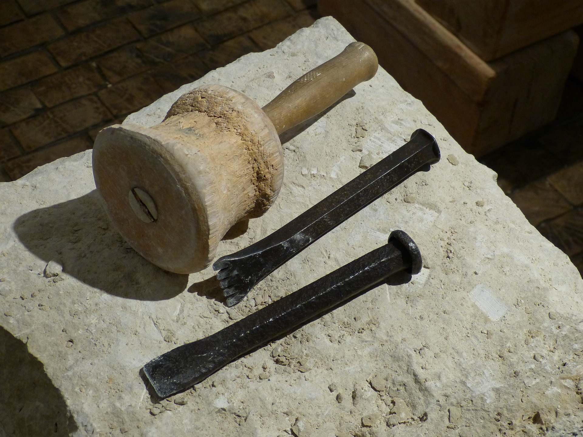 Image of two chisels and a wooden object